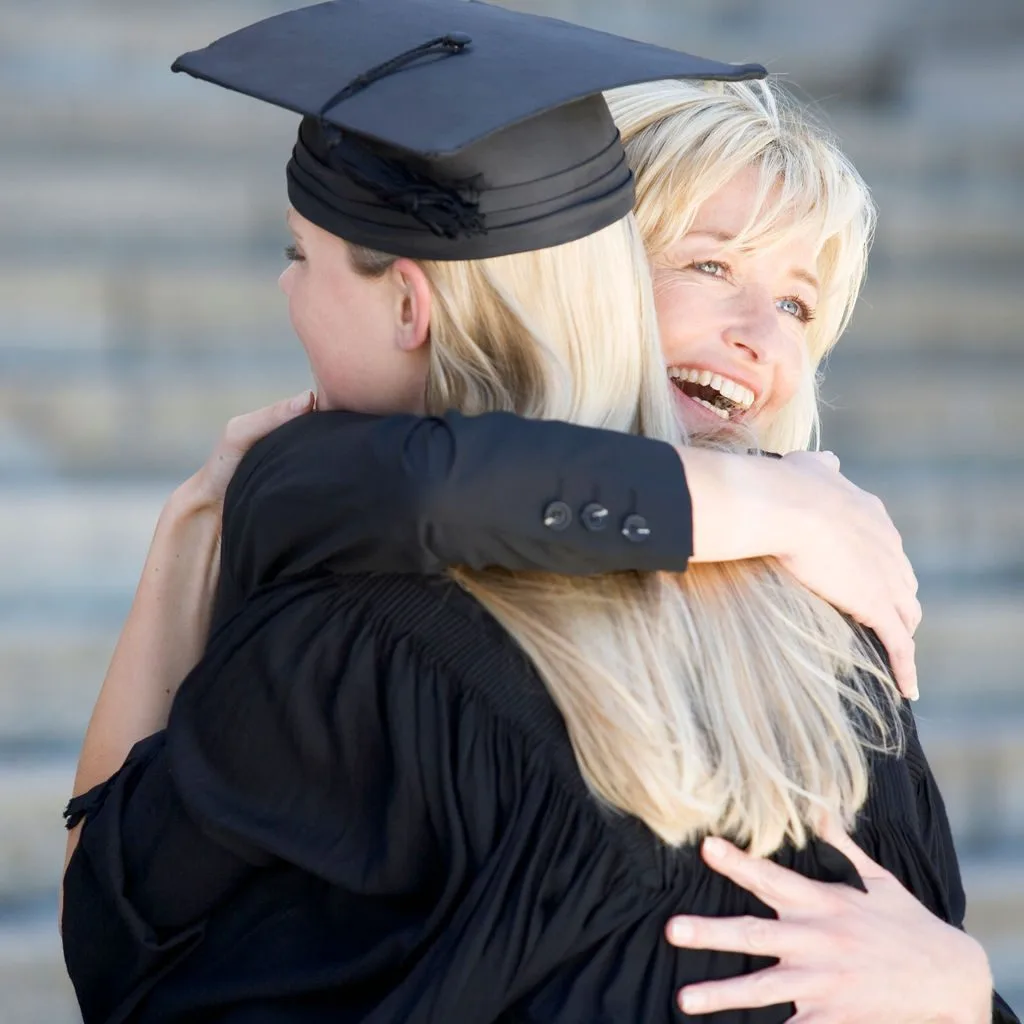 A parent embracing a graduate