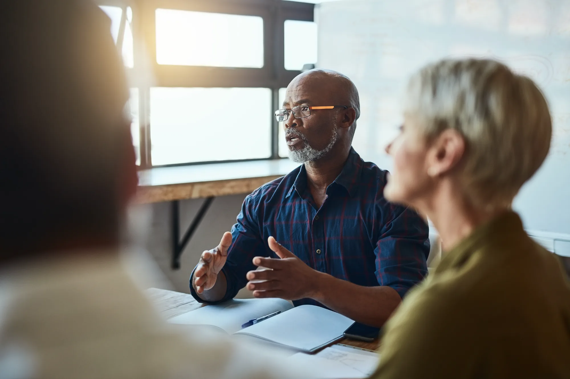 A planning conversation around a table with notes and documents