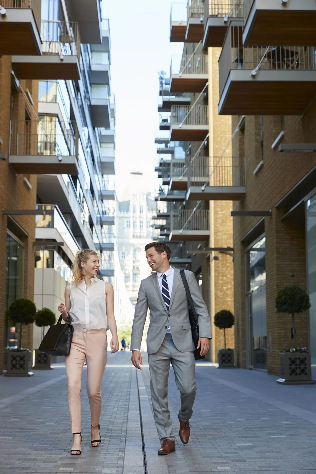 Two professionals walking and talking outside the office