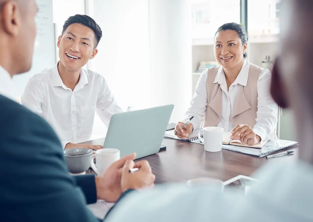 Two people reviewing plans together over coffee