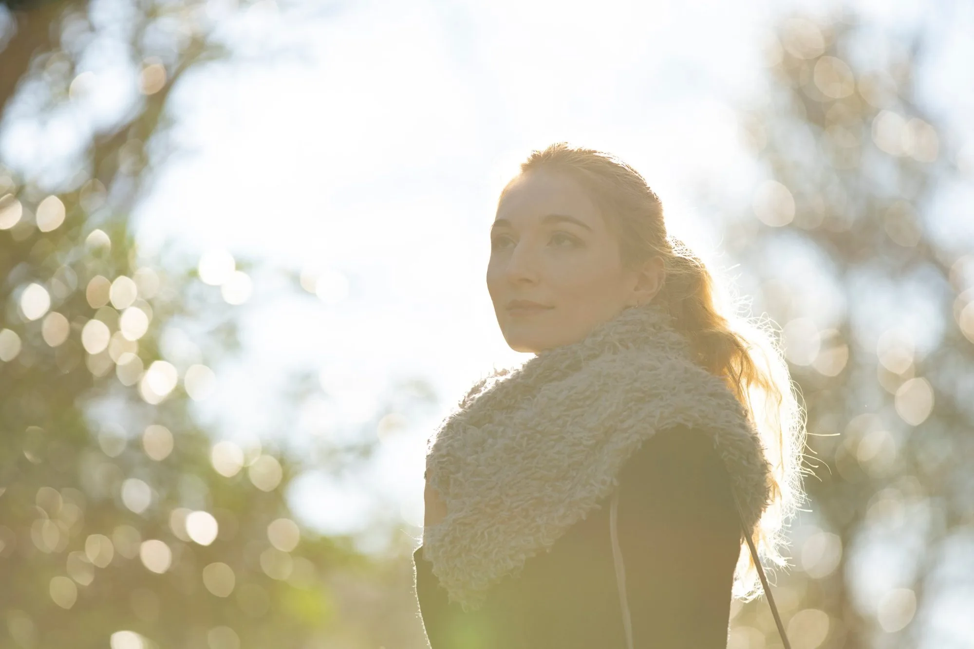 A woman outdoors in late afternoon light